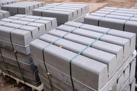 Stack of packed border stones for asphalt road on wooden pallet Stock Photos