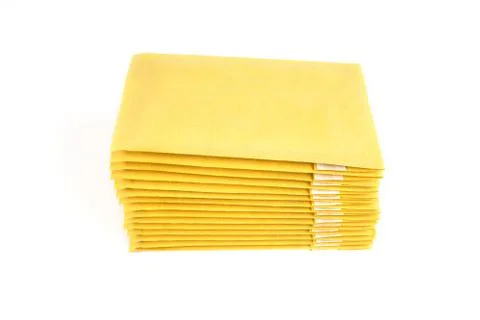A stack of padded envelopes isolated on white, top side view. Foto stock