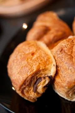 A stack of Pain au Chocolat on a Cafe style counter. Stock Photos