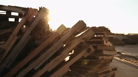 A Stack of Pallet with Sun Setting in Distance Stock Footage 68779373