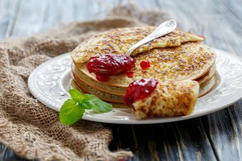 Stack of pancakes and teaspoon with berry jam. Stock Photos