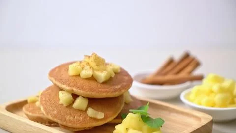 Stack of pancakes with apple chunks on a wooden tray Stock Photos