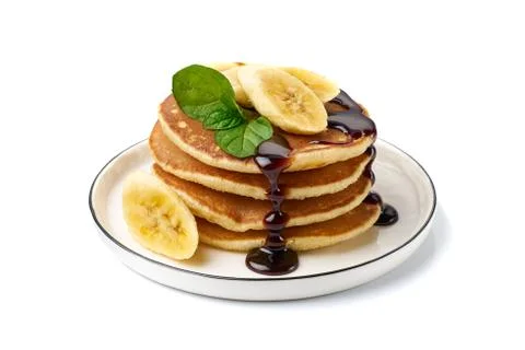 Stack of pancakes with banana,mint leaf and chocolate syrup on white Stock Photos