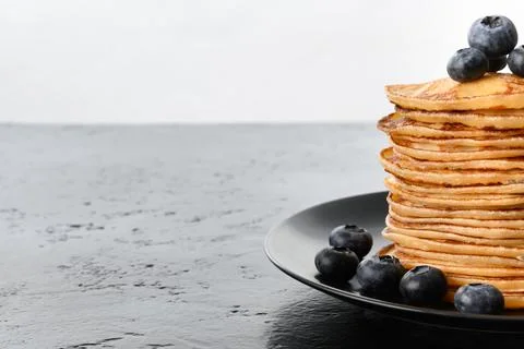Stack of pancakes with blueberry on black table Copy space Foto stock