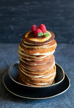 Stack of pancakes for breakfast with raspberries and mint on dark background Stock Photos