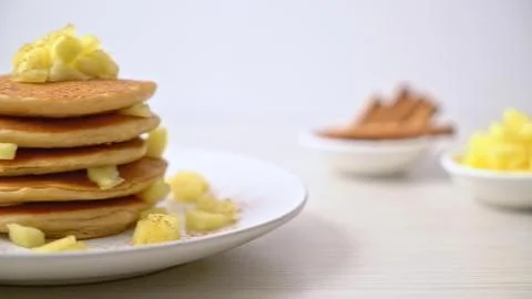 Stack of pancakes with butter and syrup on a white plate Stock Photos