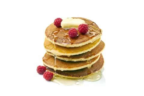 Stack of pancakes with butter, honey and raspberries on white Stock Photos
