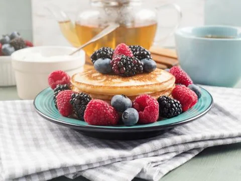 Stack of pancakes with colorful berries Stock Photos