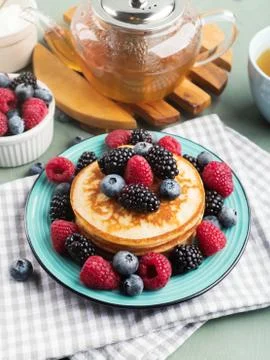 Stack of pancakes with colorful berries Stock Photos