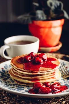 Stack of pancakes with cornelian cherry jam on plate Stock Photos