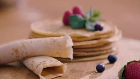 Stack of Pancakes decorated with fresh berries and mint Stock Footage 140780730