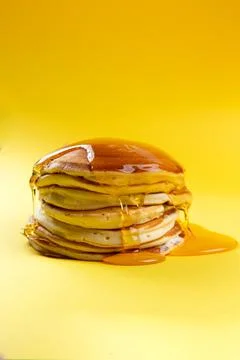 A stack of pancakes drizzled with syrup. Stock Photos