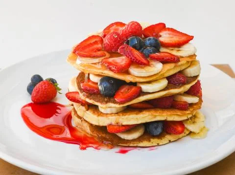 Stack of Pancakes with Fresh Berries and Bananas Photos