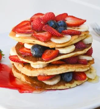 Stack of Pancakes with Fresh Berries and Bananas Фото
