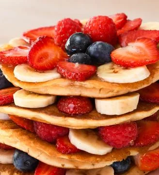 Stack of Pancakes with Fresh Berries and Bananas Photos