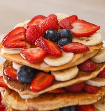 Stack of Pancakes with Fresh Berries and Bananas Photos
