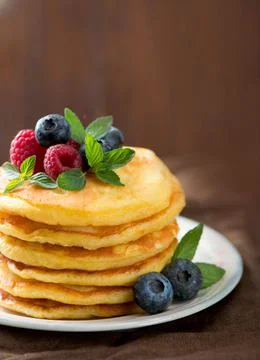 Stack of pancakes with fresh berries, close-up. Stock Photos