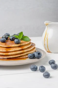 Stack of pancakes with fresh blueberry and caramel syrup Stock Photos