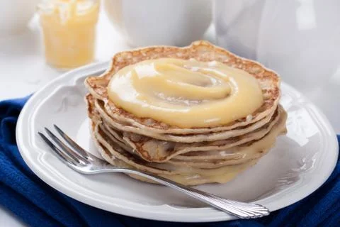 Stack of pancakes with homemade lime curd. Stock Photos