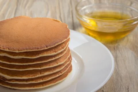 Stack of pancakes with honey for breakfast Stock Photos
