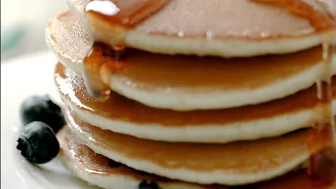 Stack of Pancakes with Melting Butter. adds maple syrup to pancakes in kitchen. Stock-Footage 336589032