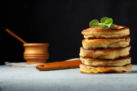 Stack of pancakes with mint on light surface Stock-Fotos