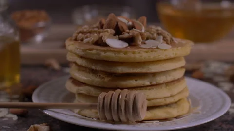 Stack Of Pancakes with Nuts Topping 4K Video stock 131610761