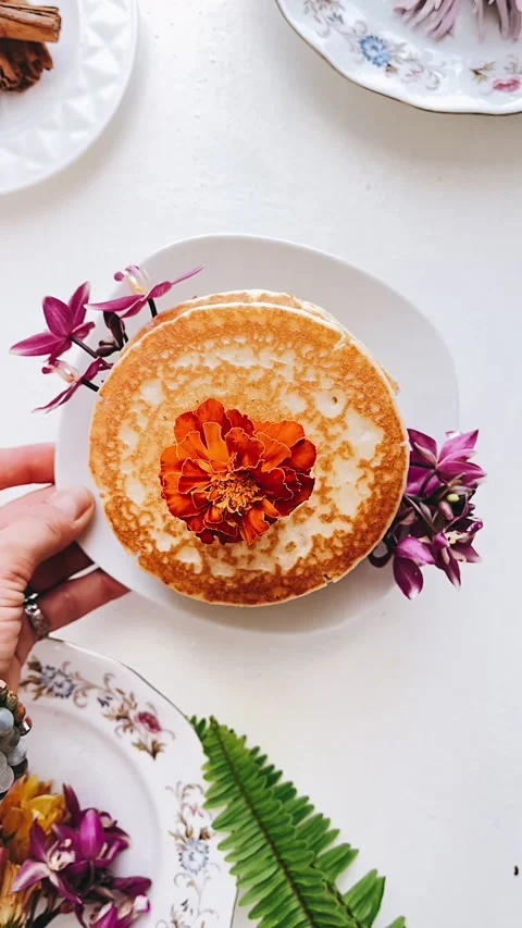 Stack of pancakes paired with Plants and flower, Breakfast Table, Stock Footage 227406986