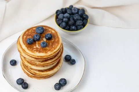 Stack of pancakes on plate with blueberries, top view Stock Photos