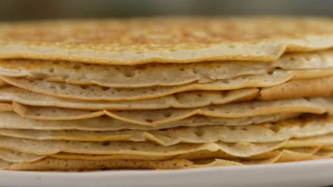 A stack of pancakes is on a plate. Camera movement. Big round pancake. Cooking Stock Footage 145489713