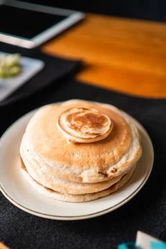 Stack of Pancakes with a Small Pancake on Top for Dessert Stock Photos