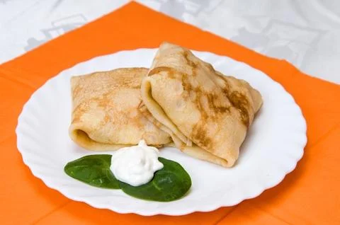 Stack of pancakes with stuffing on a white plate Stock Photos