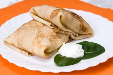 Stack of pancakes with stuffing on a white plate Stock Photos