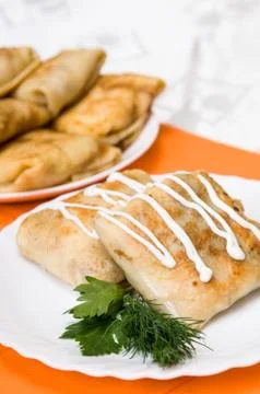 Stack of pancakes with stuffing on a white plate Stock Photos