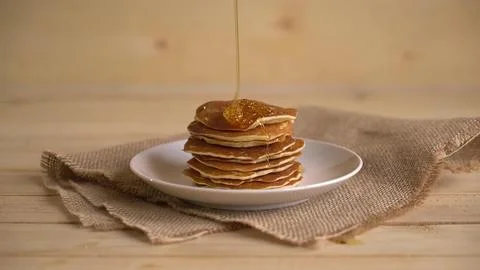 Stack of pancakes with syrup on a white plate Stock Photos
