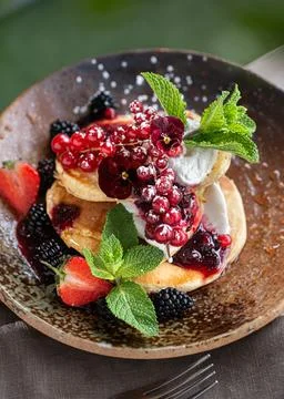 Stack of Pancakes with Whipped Cream and Fresh Berries. Stock Photos