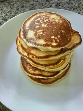 Stack of pancakes on white plate at the table Stock Photos