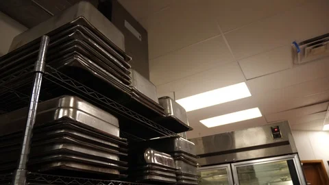Stack of pans pots bowls dishes in kitchen organization on rack in restaurant Video stock 89383977