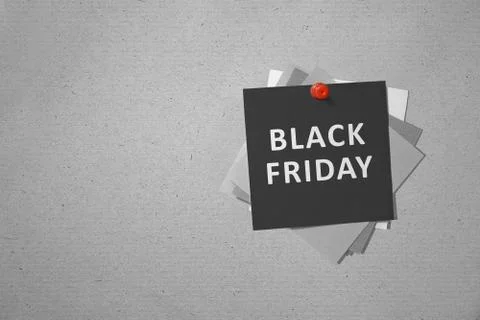 Stack of the paper with Black Friday text hanging on the wall Stock Photos