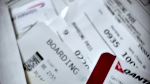 Stack of paper boarding passes on a table ready for air travel. rack focus shot Stock Footage 332393094