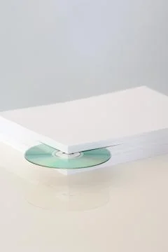 Stack of paper with CD emerging from the corner 스톡 사진