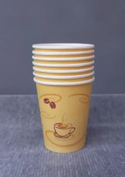 Stack of Paper Coffee Cups on Gray Background Foto stock