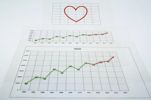 Stack of paper documents with financial reports and a big red heart isolated  Stock Photos