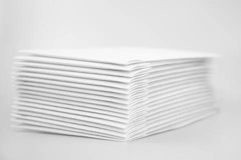 Stack of paper envelopes on white background. A pile of DVDs and CDs in white Stock Photos