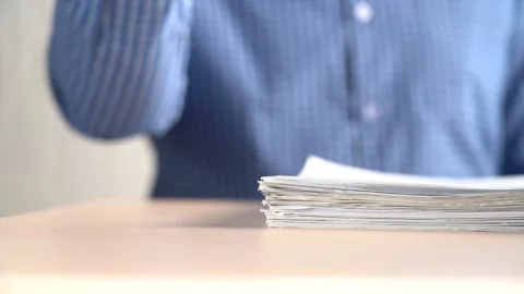 A Stack Of Paper Files Falls On The Table. Office work concept. Stock Footage 167885279