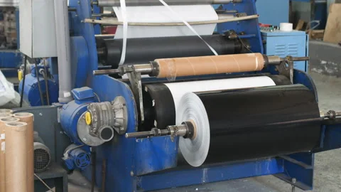 Stack of paper with just now printed material from publishing conveyor Stock Footage 85831752