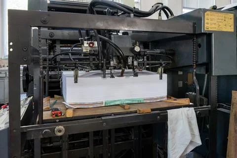 A stack of paper is loaded into a typewriter Foto stock