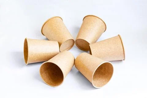 Stack of paper mugs. Six disposable paper cups made of cardboard kraft paper. Stock Photos