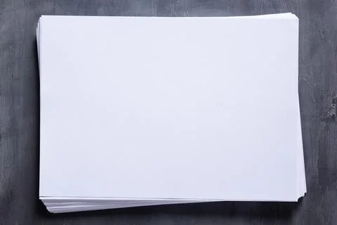 Stack of paper sheet with empty pages on table background. Creative idea conc Stock Photos