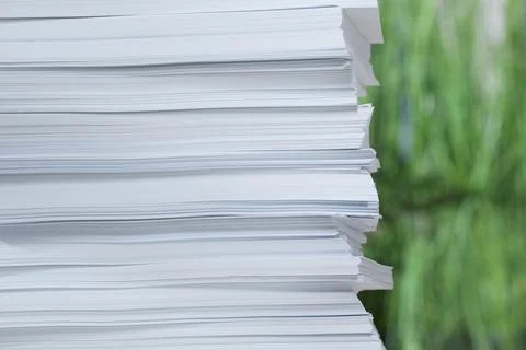 Stack of paper sheets against blurred background, closeup. Space for text 스톡 사진